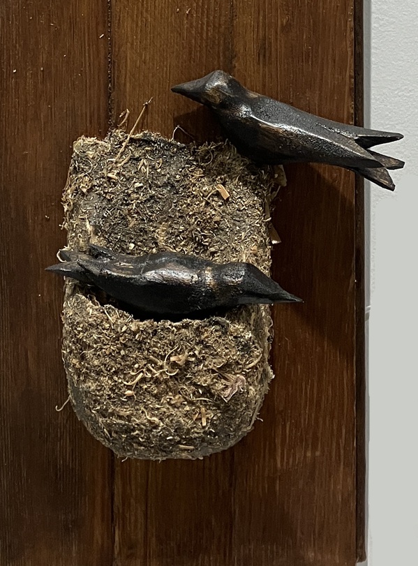 carved birds and nest