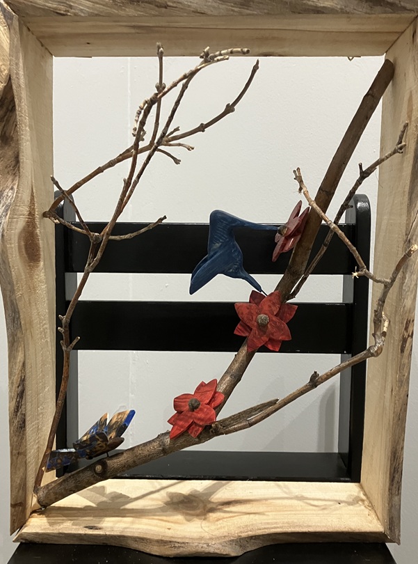 carved birds in wooden frame