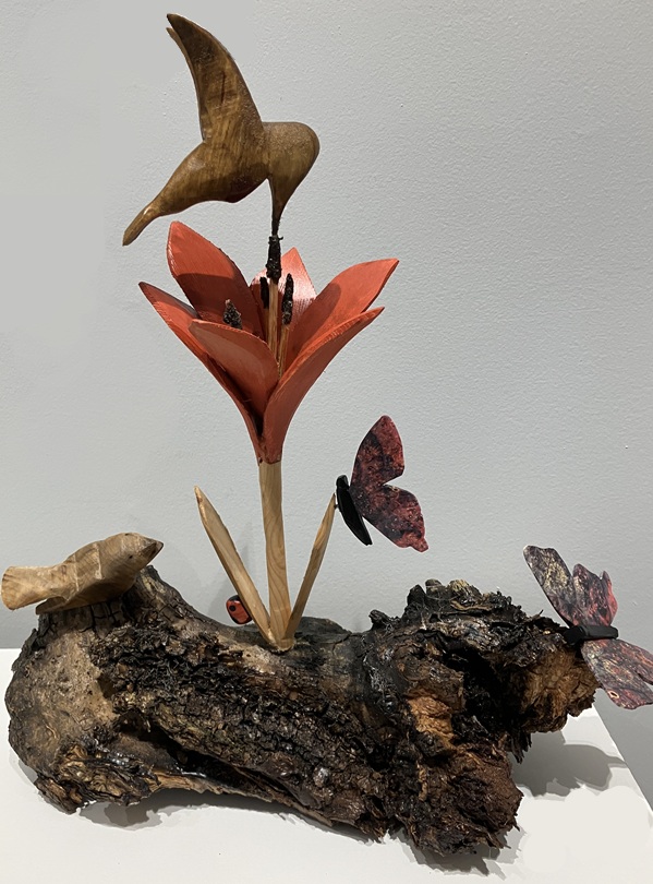 carved hummingbird, lily, and butterflies